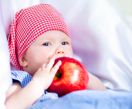 Adorable baby 5 months with appleの写真素材