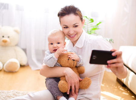 Mother holds cute babyの写真素材