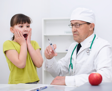 Doctor is examining a ill girlの写真素材