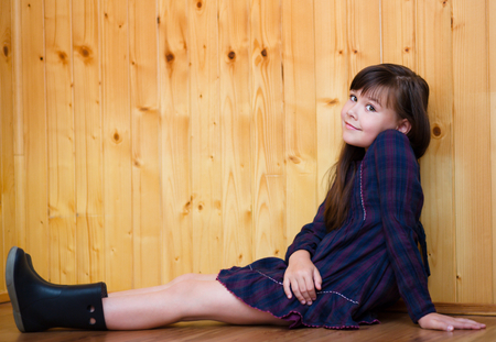 Cute girl is holding her face in astonishment and looking upの写真素材