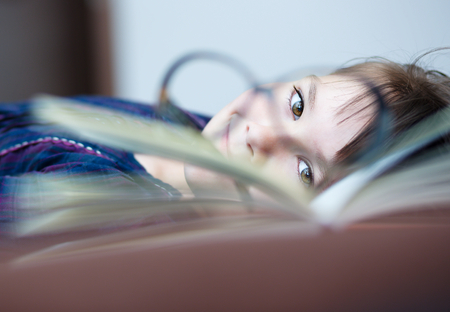 Cute girl is reading book - school, education conceptの写真素材