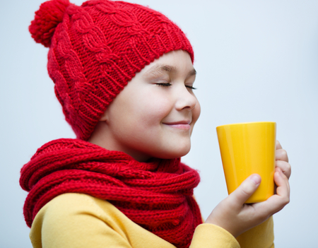 Cute girl is drinking teeの写真素材