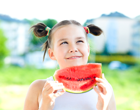 Cute girl is eating watermelonの写真素材