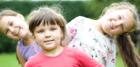 Three girls playing in park. Friends, sisterの写真素材