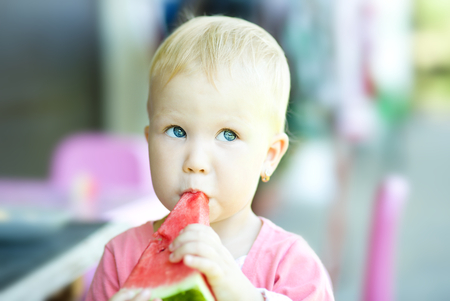 Little cute girl is eating watermelonの写真素材