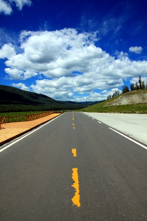 Country highway and sky with cloudsの写真素材