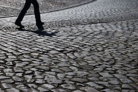 tourist walking up the cobblestone pavement of Edinburgh castleの写真素材