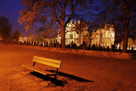 lonesome bench with the illuminated Melrose Abbey, Scotland in behindの写真素材