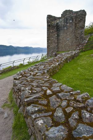 Urquhart Castle surrounded by the famous Loch Nessの写真素材