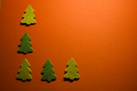 five little christmas trees on red paperの写真素材