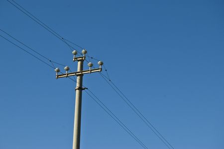 electrical tower with cables running diagonal through the photoの写真素材