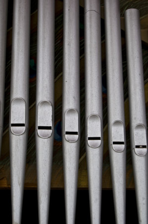 closeup of silver organ pipes in a rowの写真素材