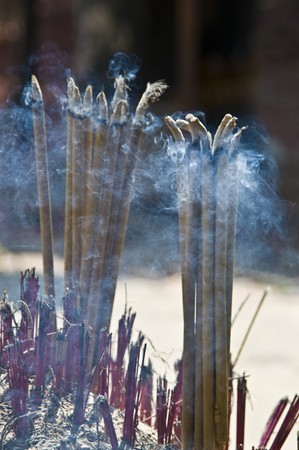 burning incense sticks in a thai templeの写真素材