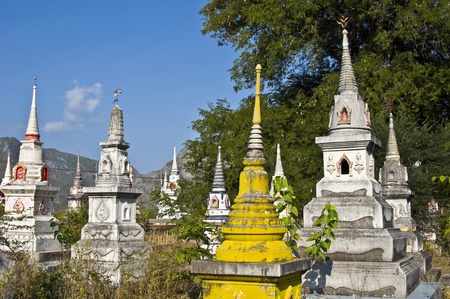 beautiful old colorful chedis on a a thai cemeteryの写真素材
