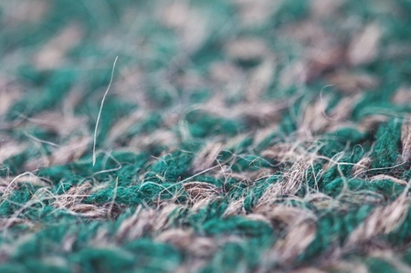 closeup of a knitted piece of mostly green woolの写真素材