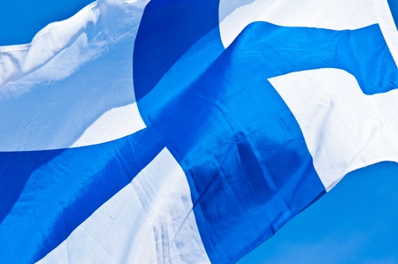 finnish flag fluttering in the wind on a sunny dayの写真素材