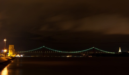 view of the illuminated Padrao dos Decobrimentos in Lisbon at nightの写真素材