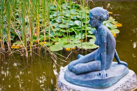 pond with a sculpture and water lilies on Margaret Island in Budapestの写真素材