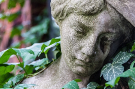 detail of a mourning sculpture on a cemeteryの写真素材