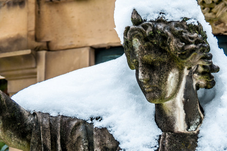 detail of a mourning sculpture on a cemeteryの写真素材