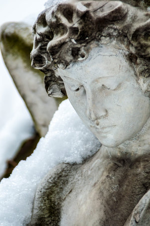 detail of a mourning sculpture on a cemeteryの写真素材