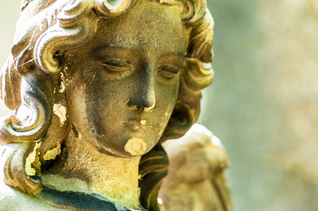 detail of a mourning sculpture on a cemeteryの写真素材