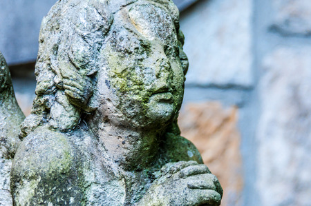 detail of a mourning sculpture on a cemeteryの写真素材