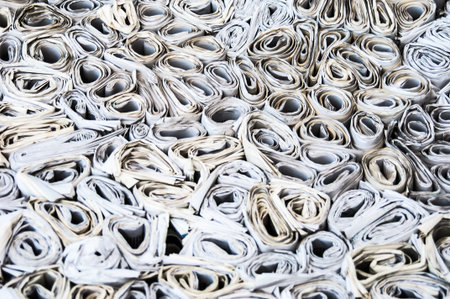 background of lots of rolls of newspapers