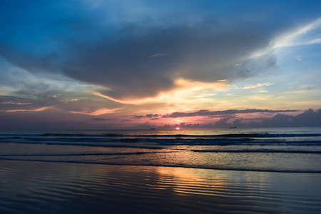 Sunrise and blue skies at the beach.の写真素材