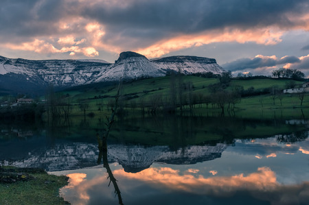 Amazing landscape reflection in the lake with snow and beautiful sunsetの写真素材