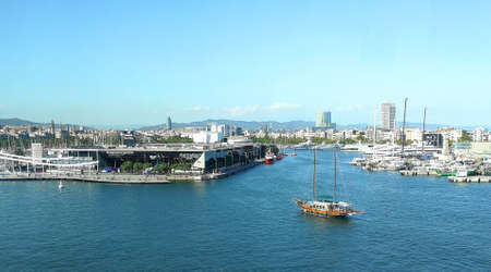 Port Vell, Barcelona. Panoramic view of the tourist port of Barcelona with a ship entering the port and the city in the background.のeditorial素材