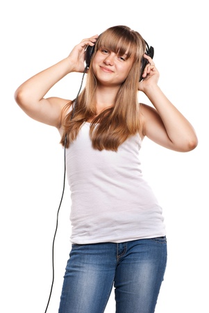 Lovely girl listening a music in headphones, white backgroundの写真素材