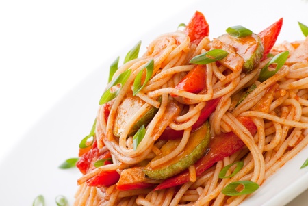 Colorful spaghetti with zucchini and tomato and grated cheeseの写真素材