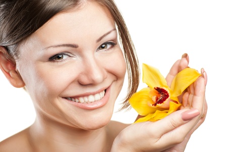 Portrait of young beautiful woman on white background with flowerの写真素材