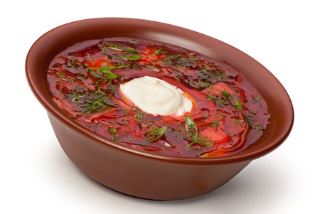Closeup of plate of ukrainian and russian national red soup with herbs on whiteの写真素材