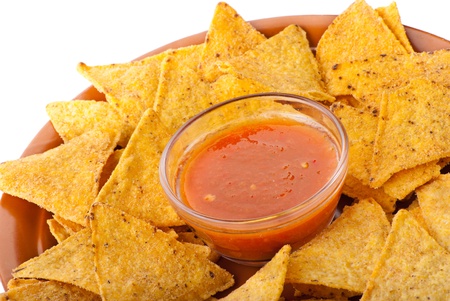 Plate of freshly made spicy nachos with tomato dip on white backgroundの写真素材