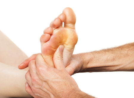 Closeup of foot receiving massage on whiteの写真素材