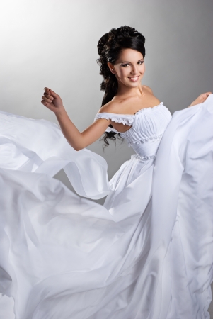 Fiance in the wind  Pretty lady in a flying wedding dress の写真素材