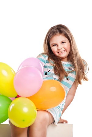 Happy girl with balloons on a white backgroundの写真素材