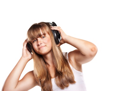 Lovely girl listening a music in headphones, white backgroundの写真素材