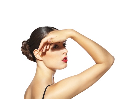Beautiful woman with red lips making shadow by her hand on the face isolatedの写真素材