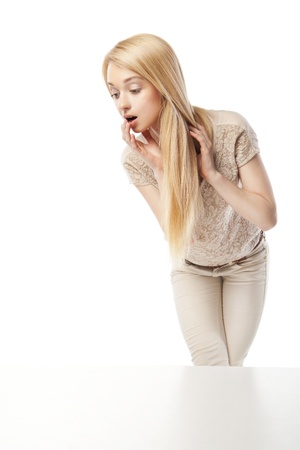 Young excited woman looking at the shop window isolated over whiteの写真素材