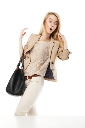 Young excited woman looking at the shop window isolated over whiteの写真素材