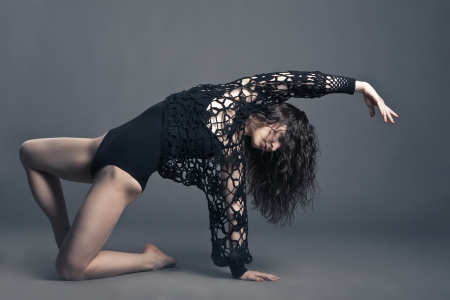 Modern style dancer posing on a studio grey backgroundの写真素材