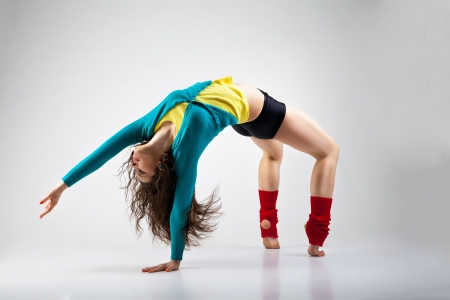 Modern style dancer posing on a studio grey backgroundの写真素材