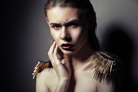 Sexy strict woman with red lips and epaulettes over dark backgroundの写真素材