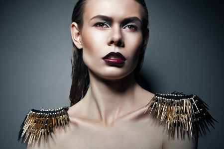 Sexy strict woman with red lips and epaulettes over dark backgroundの写真素材