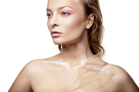 Beautyful woman with creative make-up and white paint on body isolatedの写真素材