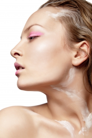 Beautyful woman with creative make-up and white paint on body isolatedの写真素材