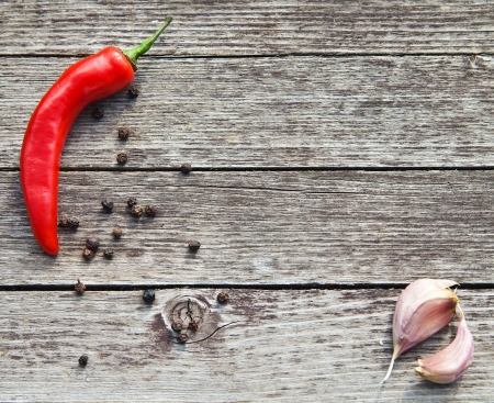 Red hot chili peppers with garlic on wooden backgroundの写真素材